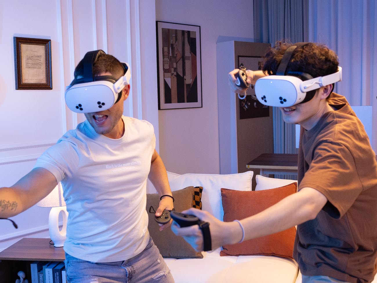 Two individuals playing VR games with K4 Boost Battery Strap