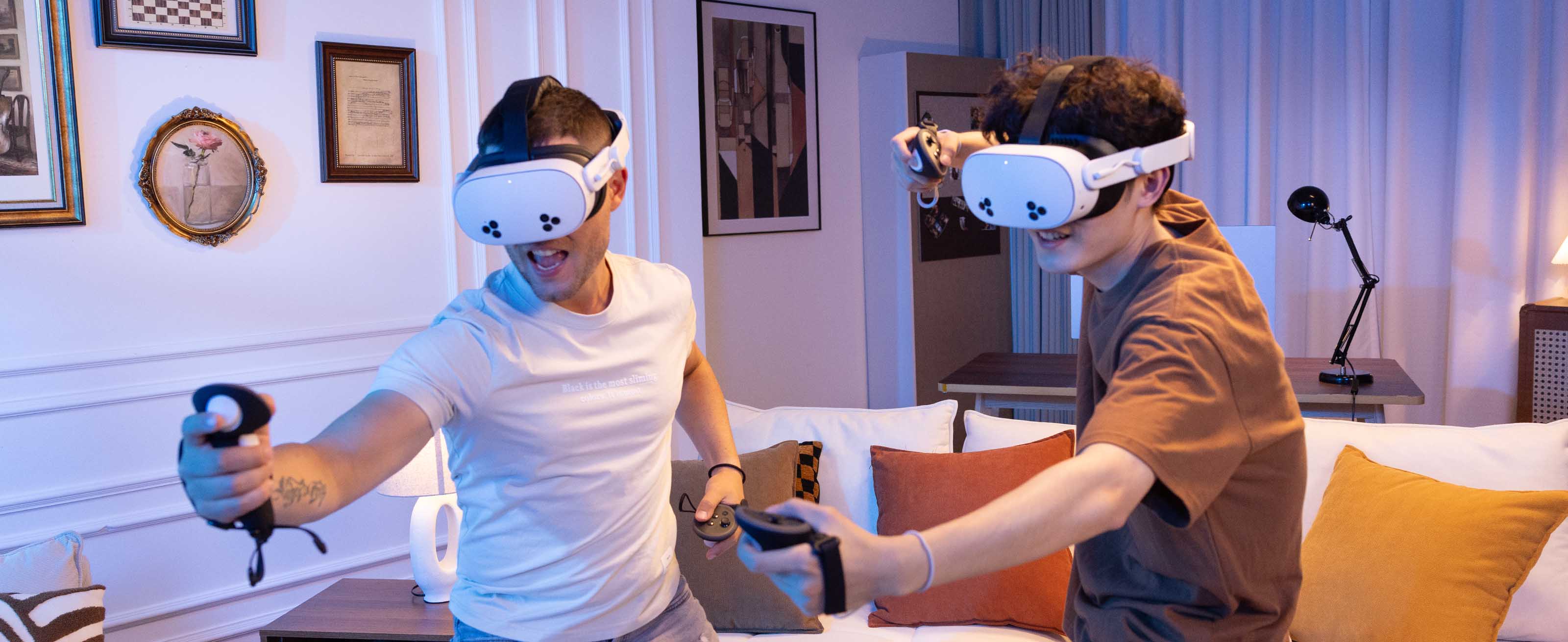 Two individuals playing VR games with K4 Boost Battery Strap