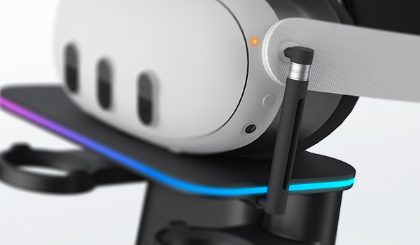 White VR headset with black motion controller and blue cable